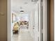 Bright condo hallway with tiled floor and bench seat leading to the open-plan living area at 5950 Pelican Bay S Plz # 603, Gulfport, FL 33707