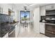 Modern kitchen featuring stainless steel appliances, granite countertops, and a breakfast nook with stunning city views at 5950 Pelican Bay S Plz # 603, Gulfport, FL 33707