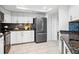 Modern kitchen featuring stainless steel appliances, sleek white cabinetry and stone backsplash at 5950 Pelican Bay S Plz # 603, Gulfport, FL 33707