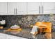 A close-up of the dark granite countertops with decor at 5950 Pelican Bay S Plz # 603, Gulfport, FL 33707