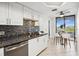 Bright kitchen with white cabinets, stainless appliances, and dining space with a view at 5950 Pelican Bay S Plz # 603, Gulfport, FL 33707
