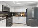 Kitchen featuring stainless steel appliances, white cabinetry, and dark granite countertops at 5950 Pelican Bay S Plz # 603, Gulfport, FL 33707