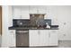 Kitchen features white cabinets, dark countertops, and stainless steel dishwasher at 5950 Pelican Bay S Plz # 603, Gulfport, FL 33707