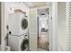 Laundry room featuring stacked washer and dryer, with view into bedroom at 5950 Pelican Bay S Plz # 603, Gulfport, FL 33707