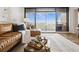 Living room featuring a large sofa, balcony access with city views, and a stylish center table at 5950 Pelican Bay S Plz # 603, Gulfport, FL 33707
