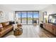 Cozy living room showcasing a leather sofa, floor-to-ceiling windows, and stunning skyline views at 5950 Pelican Bay S Plz # 603, Gulfport, FL 33707