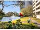 Beautiful community with a pond, walking path, landscaping, and an outdoor park bench at 5950 Pelican Bay S Plz # 603, Gulfport, FL 33707