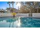 Relax by the community pool, featuring clear water and lush landscaping for a serene retreat at 5950 Pelican Bay S Plz # 603, Gulfport, FL 33707