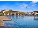 View of the community pool area from the pool deck featuring fountains and a marina backdrop at 5950 Pelican Bay S Plz # 603, Gulfport, FL 33707