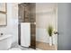 Tiled shower with glass door and adjacent toilet and decorative grass in a vase at 5950 Pelican Bay S Plz # 603, Gulfport, FL 33707