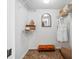 Walk-in closet with tile flooring, wire shelving, orange seating, and decorative mirror at 5950 Pelican Bay S Plz # 603, Gulfport, FL 33707