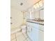 Bathroom featuring a granite countertop, white cabinets, and a tiled shower with a bench at 601 N Keene Rd # P9, Clearwater, FL 33755