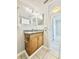 Bathroom featuring wood cabinet, granite counter, large mirror and tile floors at 601 N Keene Rd # P9, Clearwater, FL 33755