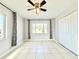 Bedroom features tile flooring, ceiling fan, two large windows and neutral paint at 601 N Keene Rd # P9, Clearwater, FL 33755