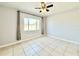 Bright bedroom with tile flooring, ceiling fan, large window and neutral paint at 601 N Keene Rd # P9, Clearwater, FL 33755