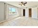 Bedroom featuring tile floors, light grey walls, and a neutral decor with views of the exterior at 601 N Keene Rd # P9, Clearwater, FL 33755