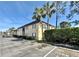 Exterior view of a condo building with palm trees and guest parking spaces at 601 N Keene Rd # P9, Clearwater, FL 33755
