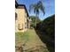 A side view of an apartment building with green grass and a tall hedge at 601 N Keene Rd # P9, Clearwater, FL 33755