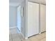 Hallway featuring tile floors, a mirror, and multiple closets with white bi-fold doors at 601 N Keene Rd # P9, Clearwater, FL 33755