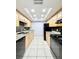 Galley kitchen featuring granite countertops, tile backsplash, and black appliances at 601 N Keene Rd # P9, Clearwater, FL 33755
