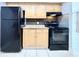 Kitchen features wood cabinets, granite countertops, and black appliances at 601 N Keene Rd # P9, Clearwater, FL 33755