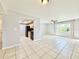 Open-concept living space with tile floors and access to kitchen with black appliances at 601 N Keene Rd # P9, Clearwater, FL 33755