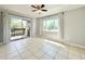 Bright living room featuring tile flooring, sliding glass doors to a balcony, and neutral decor at 601 N Keene Rd # P9, Clearwater, FL 33755