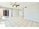 Bright living room with tile floors, ceiling fan and sliding door access to outdoors at 601 N Keene Rd # P9, Clearwater, FL 33755