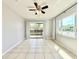 Bright living room featuring tile flooring, sliding glass doors to a balcony, and neutral decor at 601 N Keene Rd # P9, Clearwater, FL 33755