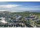 Panoramic aerial view of a waterfront community showcasing canals leading to open water at 6311 Bayside Dr, New Port Richey, FL 34652
