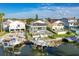 Aerial view of waterfront homes, with docks and boat lifts, nestled along canals and scenic landscaping at 6311 Bayside Dr, New Port Richey, FL 34652