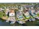 Aerial view of waterfront homes on a canal with private pools and boat docks at 6311 Bayside Dr, New Port Richey, FL 34652