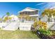 Backyard featuring a screened-in porch and lush landscaping at 6311 Bayside Dr, New Port Richey, FL 34652