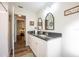 Bright bathroom with granite counters, double vanity, walk-in shower, and wood-look flooring at 6311 Bayside Dr, New Port Richey, FL 34652