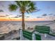 Scenic beach benches overlook the tranquil water at sunset, creating a peaceful spot to unwind at 6311 Bayside Dr, New Port Richey, FL 34652
