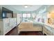 Bright bedroom featuring a large bed, a decorative dresser, and a sliding glass door leading to a balcony at 6311 Bayside Dr, New Port Richey, FL 34652