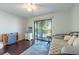 Bedroom featuring a daybed, sliding glass doors, and unique decorative pieces, creating a cozy atmosphere at 6311 Bayside Dr, New Port Richey, FL 34652