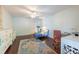 Spacious bedroom with wood floors, dresser, chair, and a comfortable workspace at 6311 Bayside Dr, New Port Richey, FL 34652