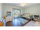 Bedroom featuring a daybed, sliding glass doors to the balcony, and colorful rugs, blending comfort and style at 6311 Bayside Dr, New Port Richey, FL 34652