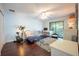 Bedroom featuring wood floors, desk, exercise bike, and a private balcony at 6311 Bayside Dr, New Port Richey, FL 34652