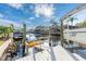 Well-maintained dock with boat lift, kayaks, and a tranquil waterfront setting with palm trees at 6311 Bayside Dr, New Port Richey, FL 34652