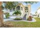 Beautiful home with arched entry, attached garage, lush landscaping, and inviting curb appeal at 6311 Bayside Dr, New Port Richey, FL 34652