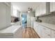 Bright kitchen features white cabinets, stone countertops and a decorative backsplash at 6311 Bayside Dr, New Port Richey, FL 34652