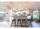 Kitchen island with seating, modern appliances, and access to outdoor patio area at 6311 Bayside Dr, New Port Richey, FL 34652