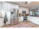 Bright kitchen with stainless steel appliances, white cabinetry, and granite countertops at 6311 Bayside Dr, New Port Richey, FL 34652