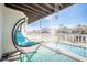 Waterfront balcony featuring a hanging chair and clear views of the canal at 6311 Bayside Dr, New Port Richey, FL 34652