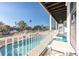 Balcony view showcasing a pool and waterway from an inviting seating area at 6311 Bayside Dr, New Port Richey, FL 34652