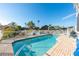 Backyard pool features brick patio, lush foliage and white aluminum fencing at 6311 Bayside Dr, New Port Richey, FL 34652