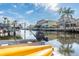 Picturesque waterfront view with boats docked along the canal, palm trees, and neighboring homes at 6311 Bayside Dr, New Port Richey, FL 34652