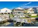 Waterfront home featuring a boat lift, dock, and scenic water views from the outdoor living space at 6311 Bayside Dr, New Port Richey, FL 34652